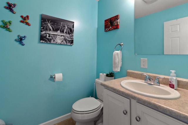 half bath featuring toilet and vanity