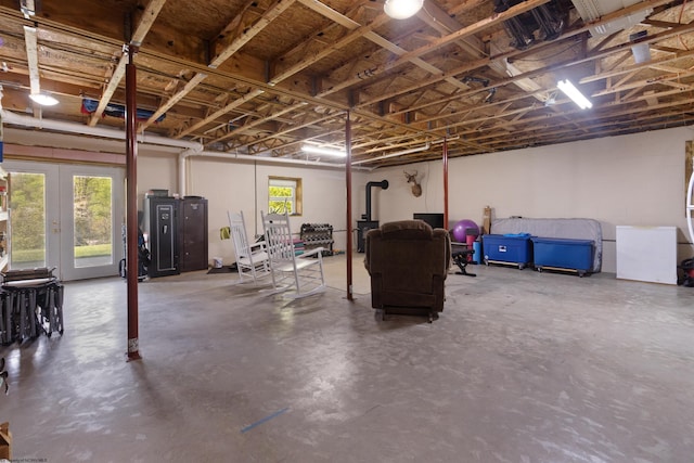 below grade area with french doors and a wood stove