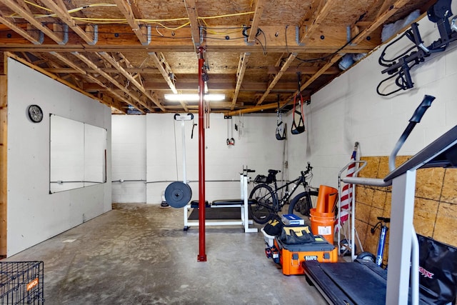 workout area with concrete block wall