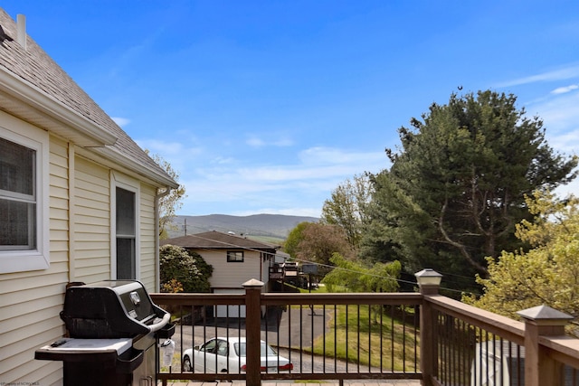 deck with a mountain view and a grill