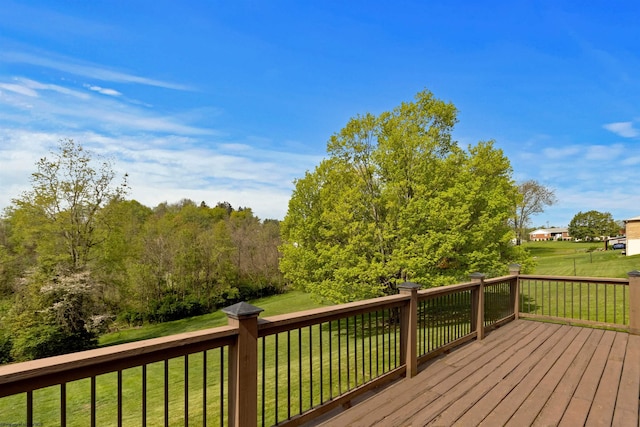 wooden terrace featuring a lawn