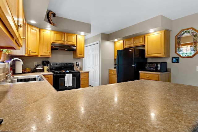 kitchen featuring a sink, under cabinet range hood, and black appliances