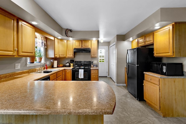 kitchen featuring a peninsula, range hood, light countertops, a sink, and black appliances