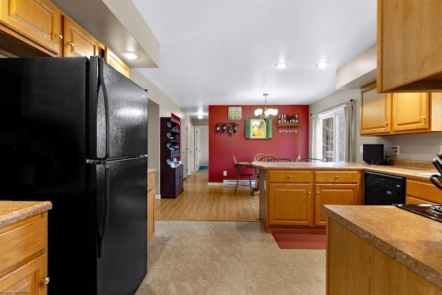 kitchen with an inviting chandelier, a peninsula, light floors, a baseboard heating unit, and black appliances