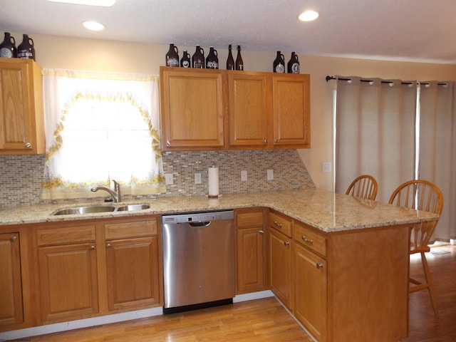 260 Donna Ave, Morgantown, WV 26505 - kitchen with a peninsula, light stone countertops, a kitchen breakfast bar, a sink, and dishwasher