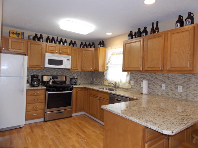 260 Donna Ave, Morgantown, WV 26505 - kitchen featuring light wood-style floors, a sink, backsplash, and stainless steel appliances