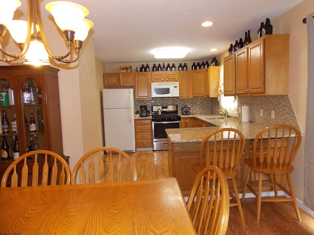 260 Donna Ave, Morgantown, WV 26505 - kitchen with white appliances, decorative backsplash, a sink, and light wood-style floors