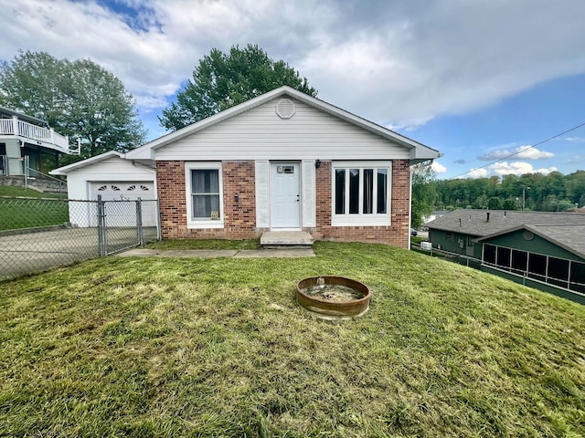 view of front of property with fence, a front yard, brick siding, concrete driveway, and an attached garage