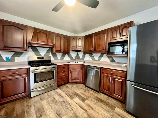 kitchen featuring light countertops, appliances with stainless steel finishes, ceiling fan, and light wood-type flooring