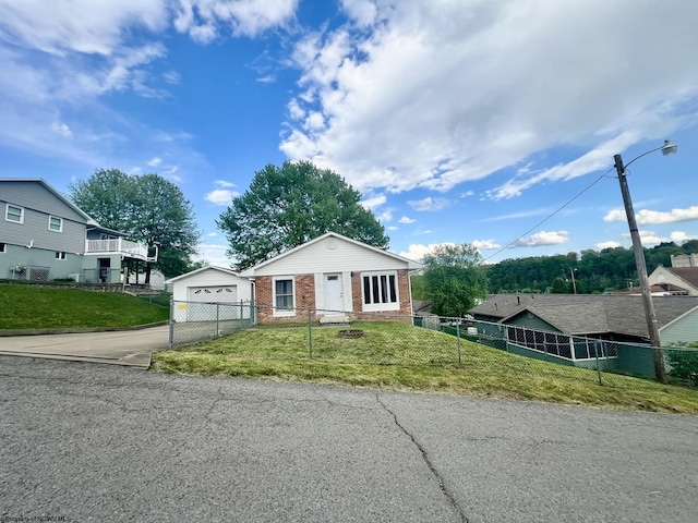 bungalow featuring an outdoor structure, driveway, fence private yard, and a front yard