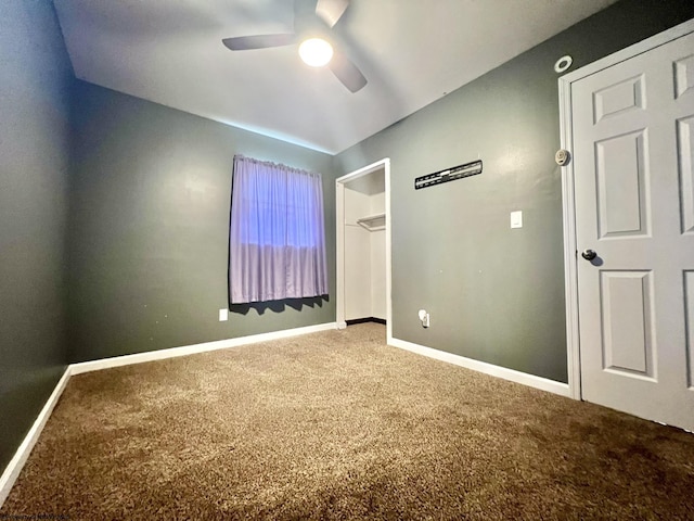unfurnished bedroom with carpet flooring, a ceiling fan, and baseboards