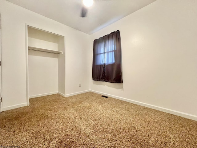 unfurnished bedroom featuring a closet, baseboards, carpet flooring, and visible vents