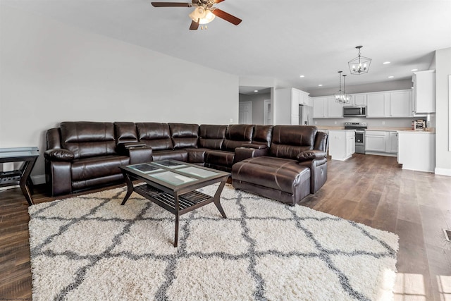 245 Charolais Cir, Fairmont, WV 26554 - living room featuring recessed lighting, ceiling fan with notable chandelier, and dark wood-style floors