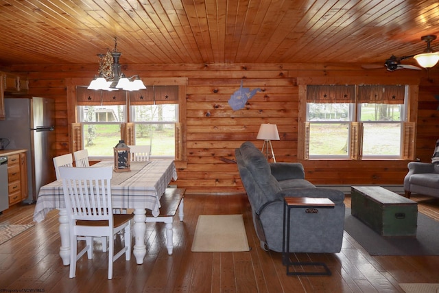 dining space with wood ceiling, ceiling fan with notable chandelier, and hardwood / wood-style floors