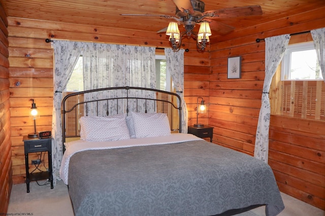 bedroom with carpet flooring, wood ceiling, and multiple windows