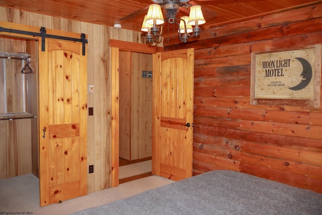 carpeted bedroom with wooden ceiling and wood walls