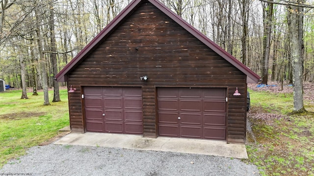 detached garage featuring a forest view