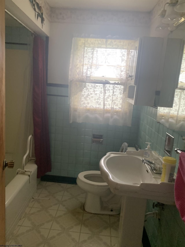 108 4th St, Spelter, WV 26438 - bathroom with tile walls, toilet, and wainscoting