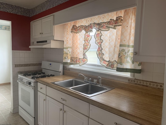 108 4th St, Spelter, WV 26438 - kitchen with a sink, wood counters, white gas range, under cabinet range hood, and decorative backsplash
