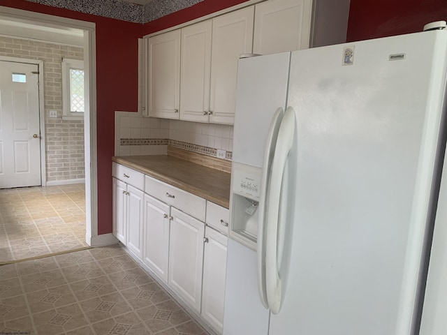 108 4th St, Spelter, WV 26438 - kitchen featuring white refrigerator with ice dispenser, white cabinetry, decorative backsplash, and wooden counters