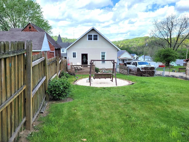 rear view of property with a yard, a fenced backyard, and a patio