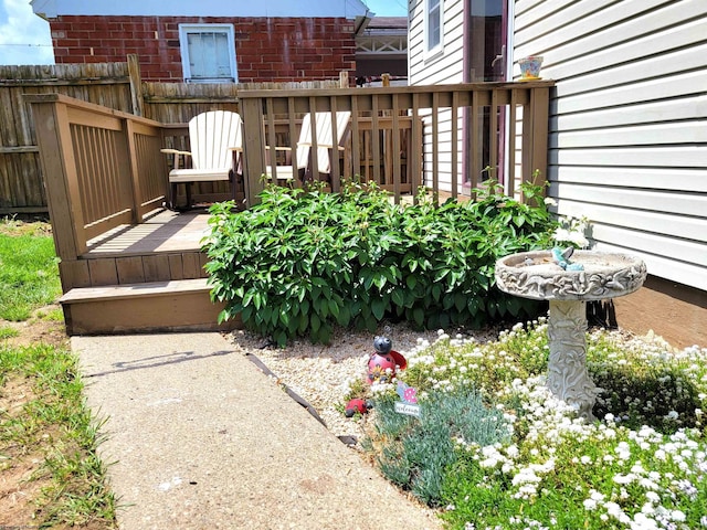 view of yard featuring fence and a wooden deck
