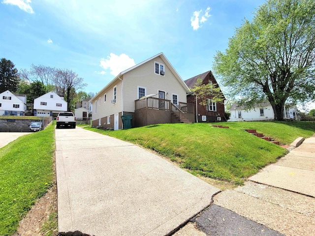 view of front of home featuring concrete driveway and a front yard