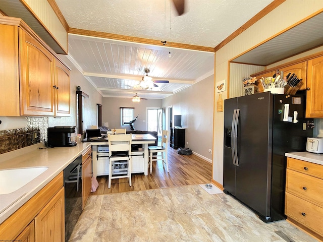 kitchen featuring black appliances, decorative backsplash, open floor plan, light countertops, and a ceiling fan