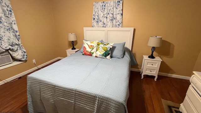 bedroom featuring baseboards and dark wood-style floors