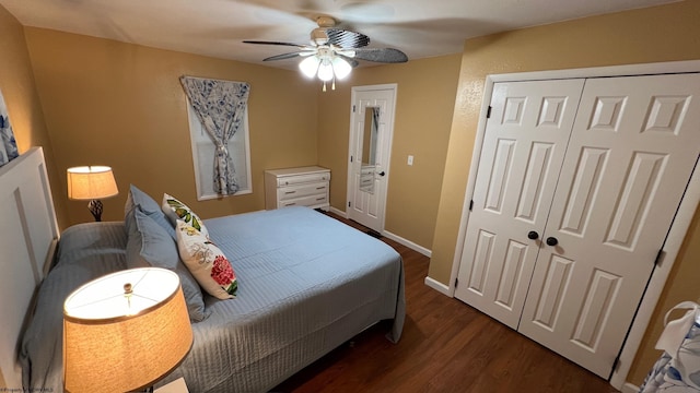 bedroom with a closet, dark wood finished floors, baseboards, and a ceiling fan