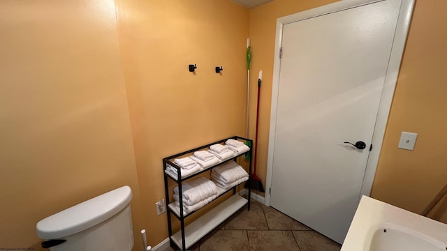 bathroom with toilet and tile patterned floors