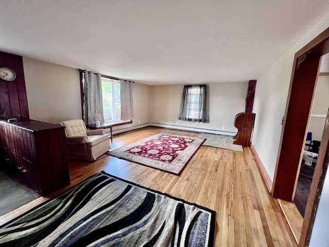 interior space with light wood-style flooring, baseboards, and baseboard heating