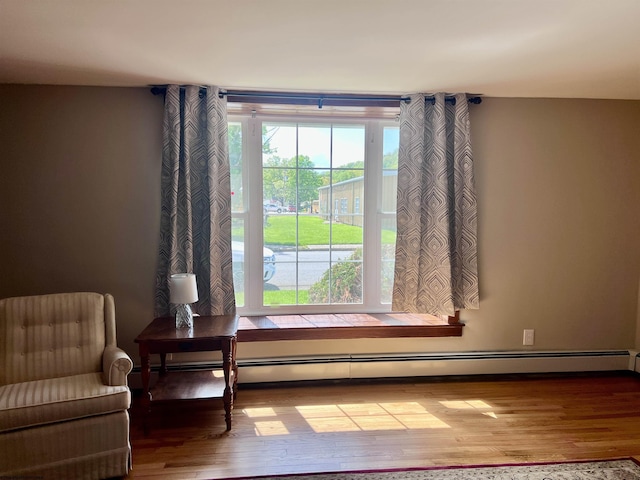 sitting room featuring wood finished floors and a baseboard radiator
