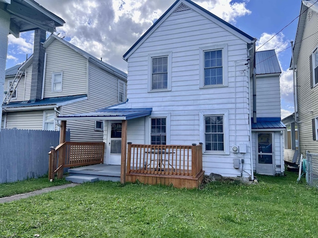 back of house with a yard, fence, and a wooden deck
