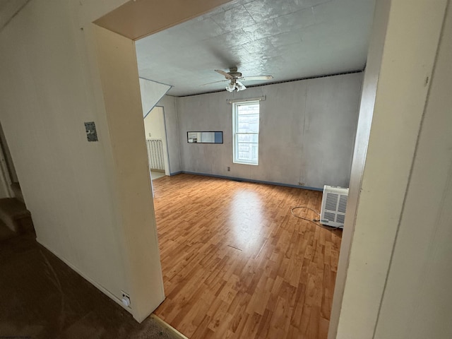 additional living space featuring a ceiling fan and wood finished floors
