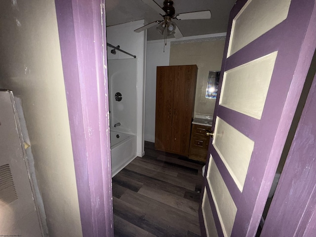 interior space featuring shower / tub combination, a ceiling fan, and wood finished floors