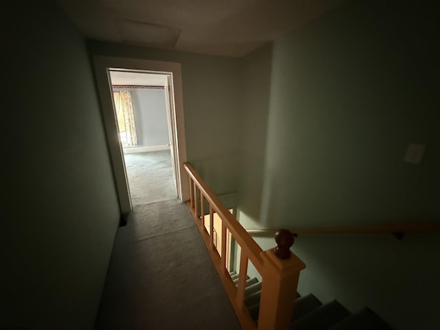 hall with an upstairs landing, attic access, and carpet