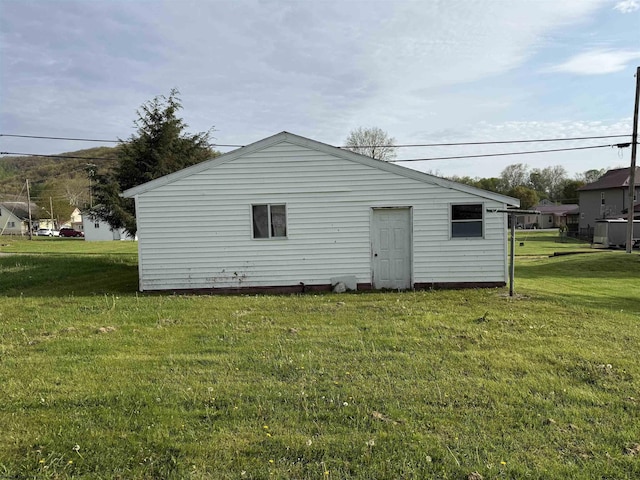back of house with a lawn