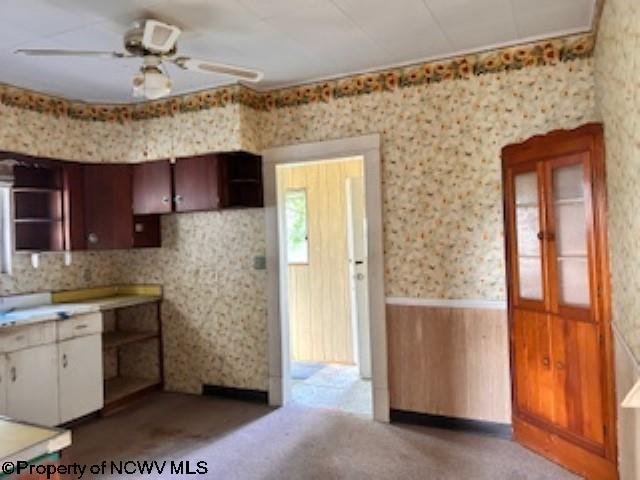 530 Newton St, Fairmont, WV 26554 - kitchen with wood walls, a wainscoted wall, open shelves, a ceiling fan, and wallpapered walls