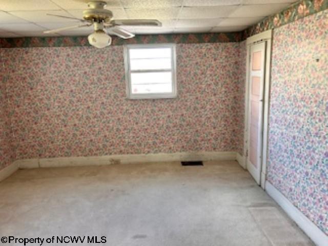 530 Newton St, Fairmont, WV 26554 - spare room with light carpet, baseboards, wallpapered walls, and a drop ceiling