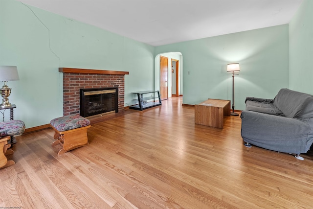 1060 Takoma St, Morgantown, WV 26505 - living area with a fireplace, arched walkways, and light wood-style floors