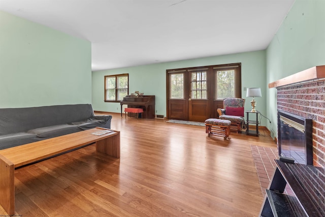 1060 Takoma St, Morgantown, WV 26505 - living area with a brick fireplace, visible vents, and wood finished floors