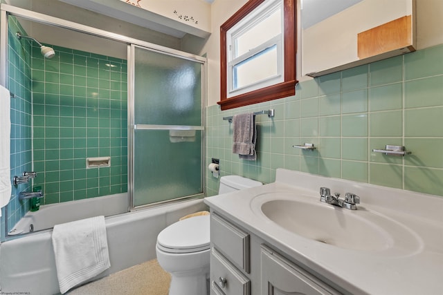 1060 Takoma St, Morgantown, WV 26505 - bathroom featuring vanity, toilet, shower / bath combination with glass door, and tile walls