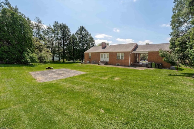 1060 Takoma St, Morgantown, WV 26505 - back of property featuring a yard, a patio area, a chimney, and brick siding