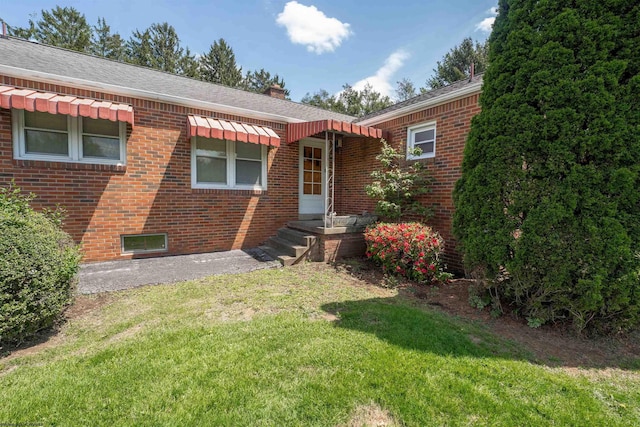 1060 Takoma St, Morgantown, WV 26505 - exterior space with a shingled roof, a chimney, brick siding, and a front yard