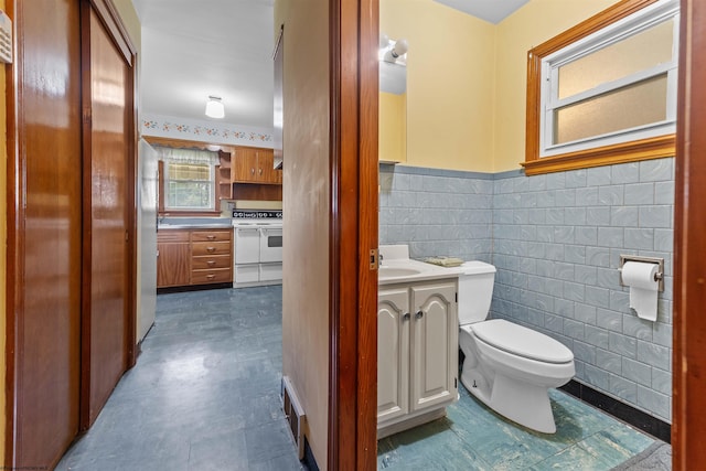 1060 Takoma St, Morgantown, WV 26505 - bathroom featuring tile walls, toilet, wainscoting, visible vents, and vanity