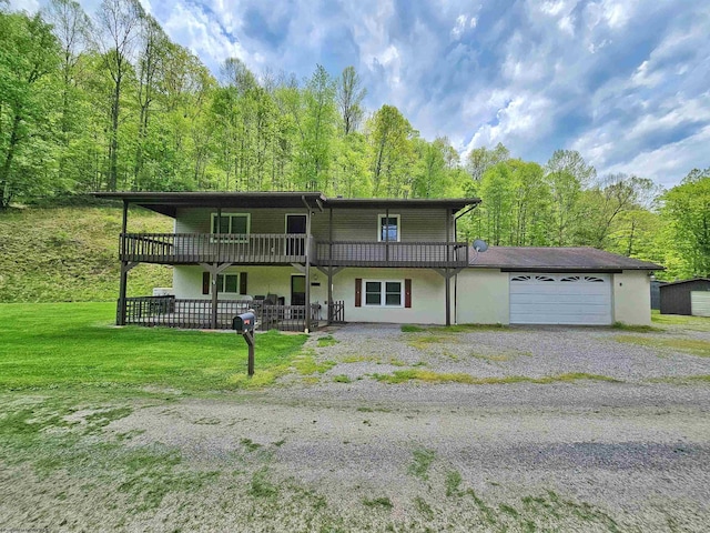 1368 Red Lick Run, New Milton, WV 26411 - rear view of house with a yard, a wooded view, a garage, and stucco siding