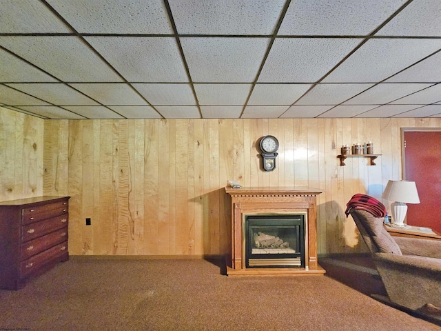 1368 Red Lick Run, New Milton, WV 26411 - living area featuring wooden walls, carpet flooring, a glass covered fireplace, and a drop ceiling
