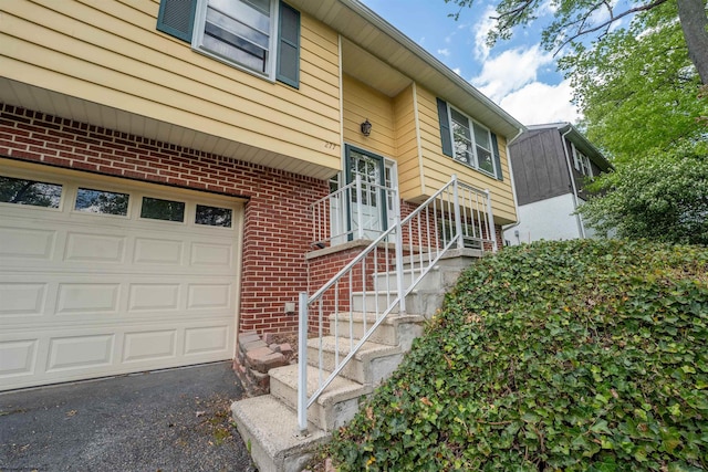 277 Randolph Rd, Morgantown, WV 26505 - doorway to property with an attached garage and brick siding