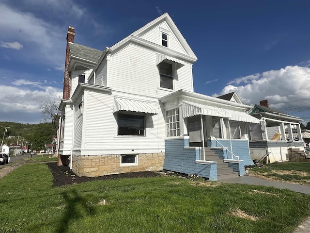 108 Marshall St, Mannington, WV 26582 - view of front of property with a chimney and a front yard